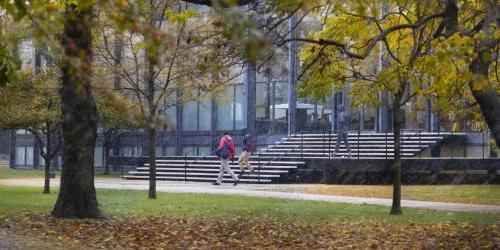 Students exit Crown Hall on a snowy fall day